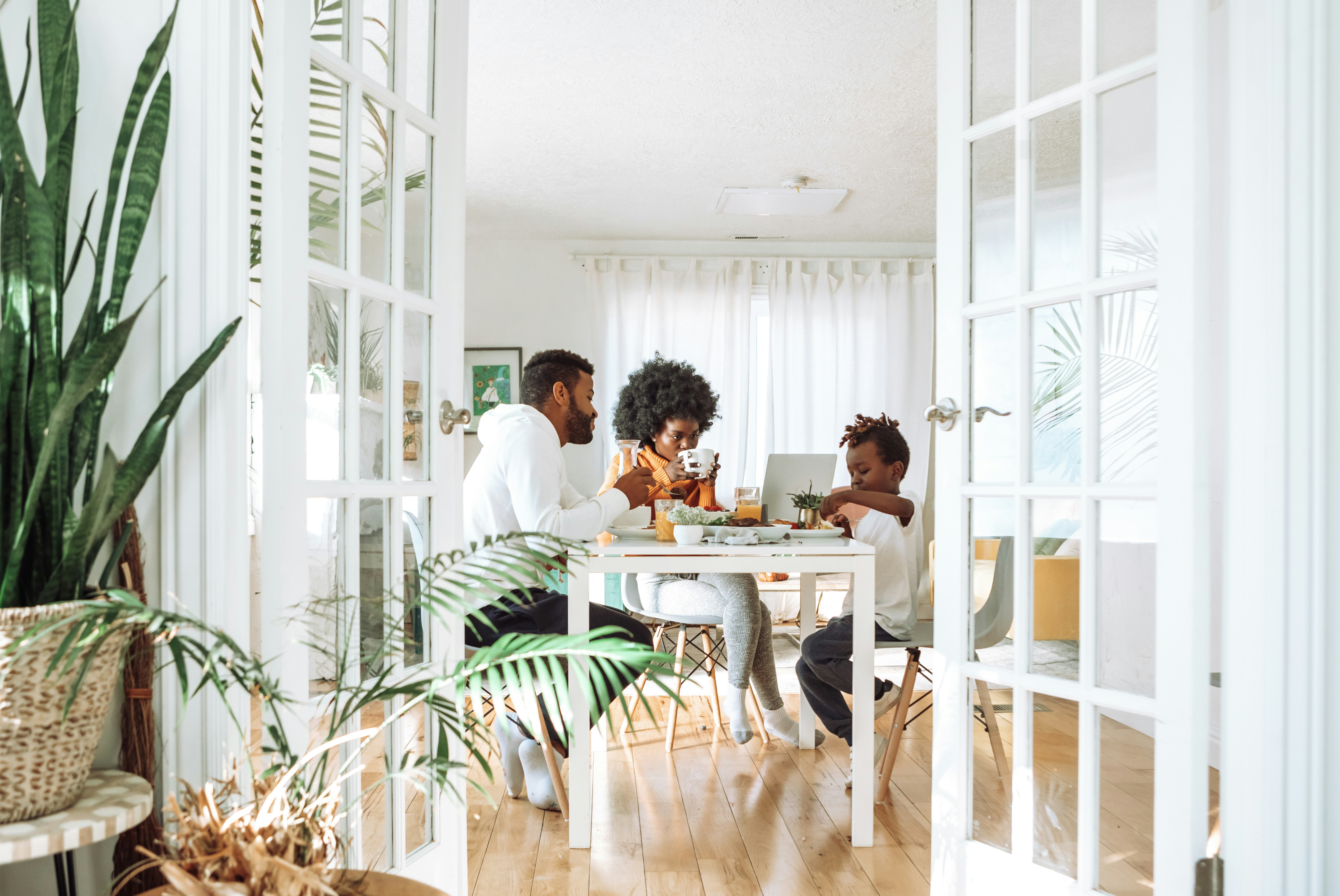 A family eating breakfast together at the table in their own home